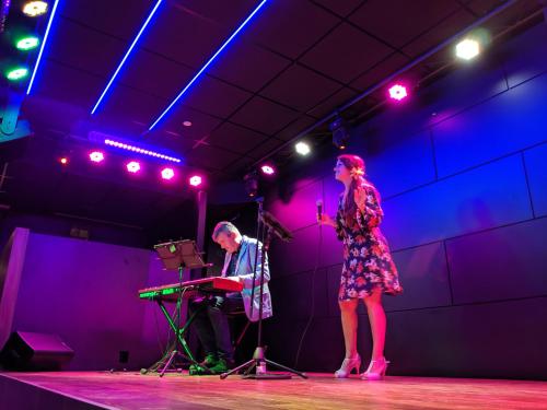 a man and a woman on a stage with a microphone at Golden Costa Salou - Adults Only 4* Sup in Salou