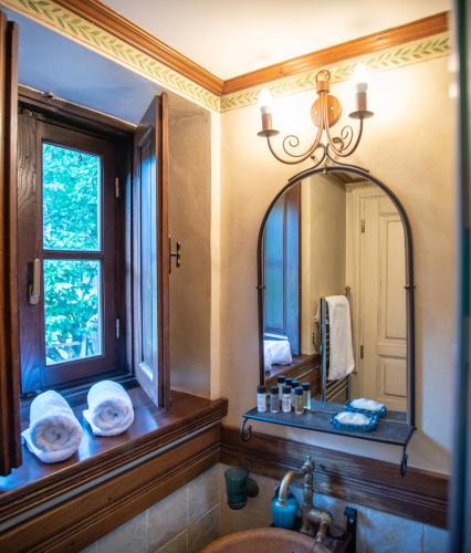 a bathroom with a sink and a mirror at Epoches in Karpenisi