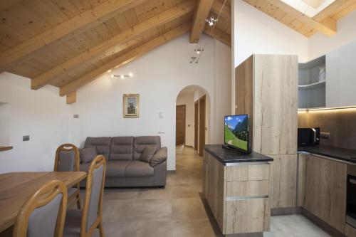 a living room with a couch and a table at Fiemme Home Mountain Apartment in Tesero