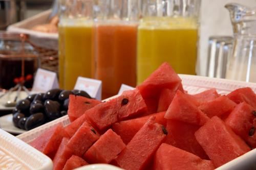 a plate of watermelon on a table with some juice at Acolpacha Tambo Boutique in Arequipa