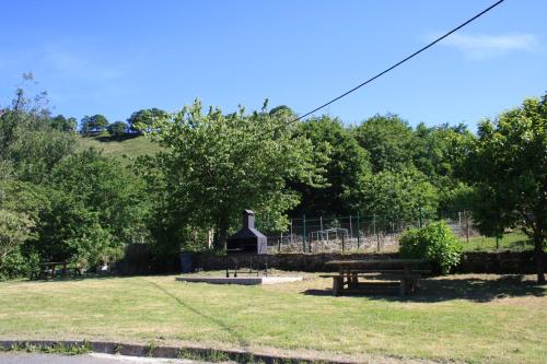a park with a picnic table and a playground at Hotel Avelina in Cangas de Onís