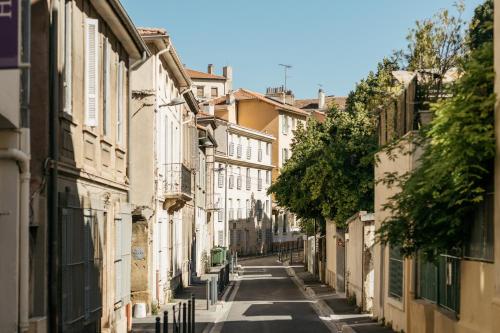 an empty street in a city with buildings at Hôtel Boutique Cézanne centre Aix-en-Provence in Aix-en-Provence