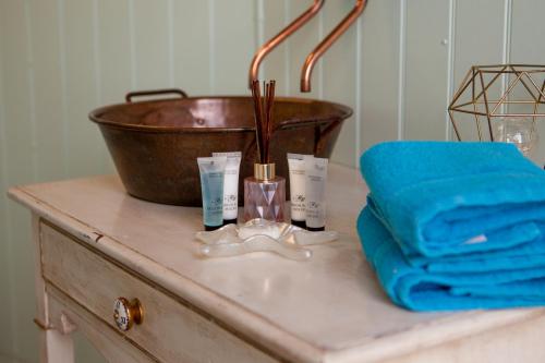 a counter with a bowl and someented products on it at Quex Livery Glamping in Birchington