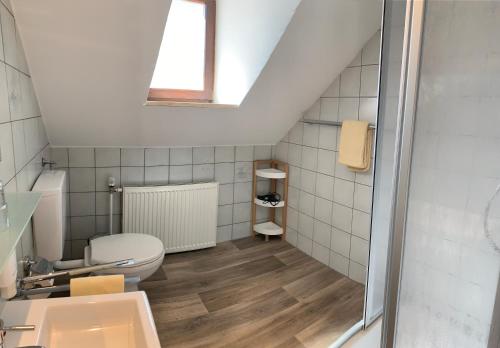 a bathroom with a toilet and a sink at Hotel Restaurant Weihenstephaner Stuben in Landshut