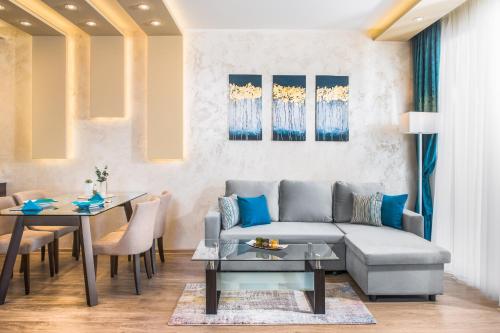 a living room with a couch and a table at Park & Spa Hotel Markovo in Plovdiv