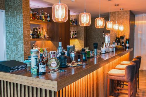 a bar with a counter with bottles of alcohol at VidaMar Resort Hotel Algarve in Albufeira