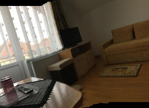 a living room with a table and a couch and a window at Casa Sterp in Jina