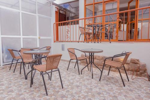 a group of tables and chairs on a balcony at Hawka Inka Hostal - Cusco in Cusco