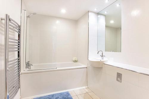 a white bathroom with a tub and a sink at Almanna, Central York, only 6 minutes walk to York Minster in York