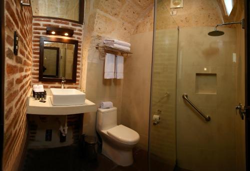 a bathroom with a toilet and a sink and a shower at Acolpacha Tambo Boutique in Arequipa