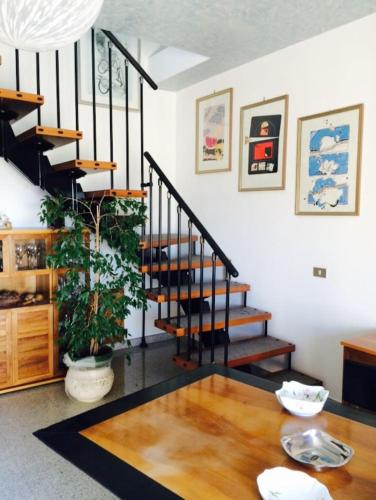 a living room with a table and a staircase at ALLEGROHOME your big nest in Barile