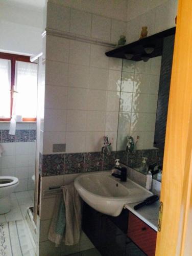 a bathroom with a sink and a toilet at ALLEGROHOME your big nest in Barile