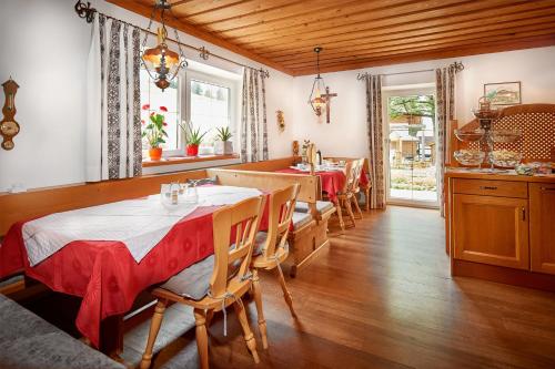 a dining room with two tables and chairs in a room at Haus Obermühle in Maria Alm am Steinernen Meer