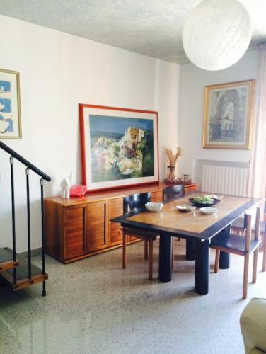 a living room with a table and a painting on the wall at ALLEGROHOME your big nest in Barile