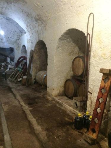 a room with a bunch of wine barrels in a cellar at ALLEGROHOME your big nest in Barile
