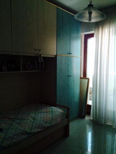 a bedroom with a bed and a window and a curtain at ALLEGROHOME your big nest in Barile