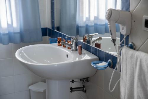 a bathroom with a white sink and a mirror at Nicotera Beach Village in Nicotera Marina