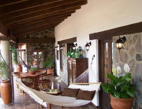 a porch with a hammock on a patio at Hotel Villa Cassis in Tapalpa