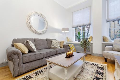 a living room with a couch and a table at Exclusive Charm of the Old Tallinn in Tallinn
