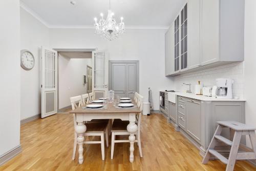 a dining room with a table and chairs in a kitchen at Exclusive Charm of the Old Tallinn in Tallinn