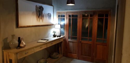 a room with a wooden cabinet and a table at Dream of Africa Bush Lodge in Marloth Park
