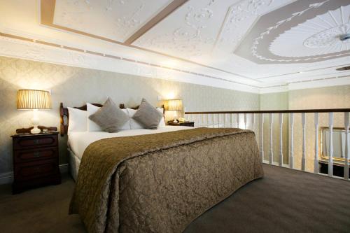 a bedroom with a large bed and a coffered ceiling at Harrington Hall in Dublin
