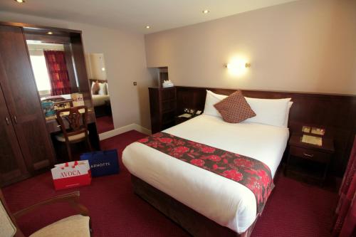 a hotel room with a large bed with flowers on it at Harrington Hall in Dublin