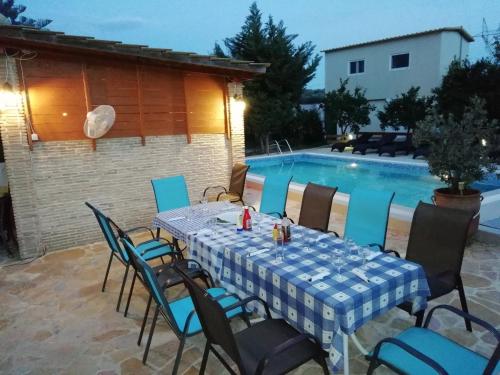 a table and chairs sitting next to a swimming pool at Evan's Studios in Alykes