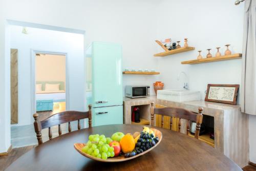 a bowl of fruit on a wooden table in a kitchen at Pasithea Suites in Megalokhori