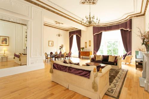 ein Wohnzimmer mit 2 Sofas und einem Esszimmer in der Unterkunft Grand in the Park in Glasgow