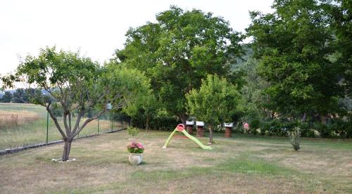 a yard with a playground with a yellow play implement at Casa Vacanze Garofoli in Genga