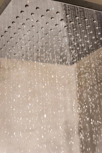 a shower head with water droplets on it at Pasithea Suites in Megalokhori