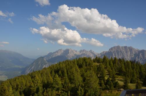 a view of a mountain with trees and clouds at Appartements Obergollerhof in Assling