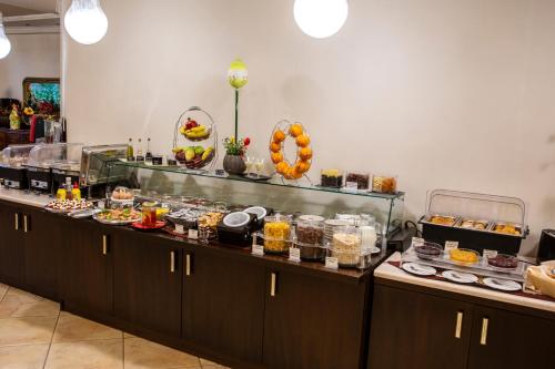 a buffet line with many different types of food at Hotel Pella in Giannitsa