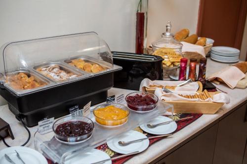 a counter top with a bunch of food on it at Hotel Pella in Giannitsa