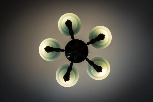 a chandelier with four lights on a wall at Pasithea Suites in Megalokhori