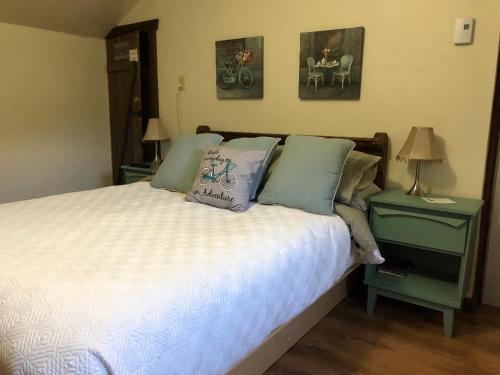 a bedroom with a bed with pillows on it at Bed and Breakfast Du Repos in Saint Quentin