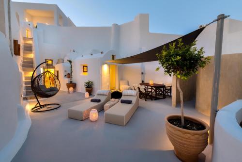 a living room with white furniture and a table at Pasithea Suites in Megalokhori