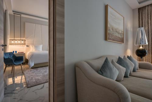 a hotel room with a couch and a bedroom at Marchica Lagoon Resort in Nador