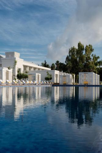 a pool of water in front of a building at Marchica Lagoon Resort in Nador