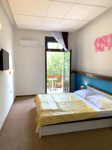 a bedroom with a bed and a large window at Pansion Ruža in Novi Vinodolski