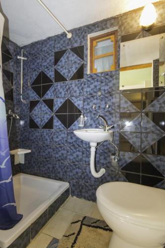 a bathroom with a sink and a toilet and a tub at Rasopasno 2 in Malinska