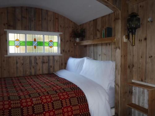 a bedroom with a bed and a window at Black Mountain BreakAway in Llangadog