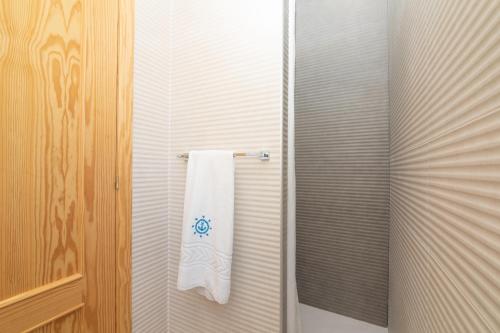 a towel hanging on a towel rack in a bathroom at Hotel Marítimo Urban in Alicante