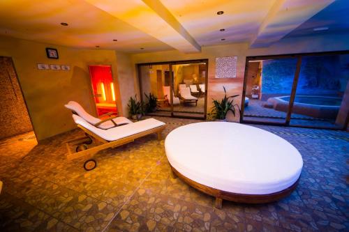 a large room with a large white bed and a table at Chalets CEDER 1 in Tatranská Lomnica