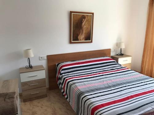 a bedroom with a bed and a picture on the wall at Villa SOLMAR in Peniscola