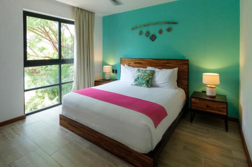 a bedroom with a large bed and a large window at San Trópico Boutique Hotel & Peaceful Escape in Puerto Vallarta