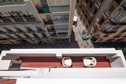 an overhead view of a building with two white chairs at Hotel Marítimo Urban in Alicante