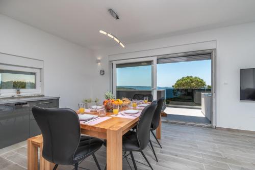 a kitchen and dining room with a table and chairs at Villa Helena in Trogir