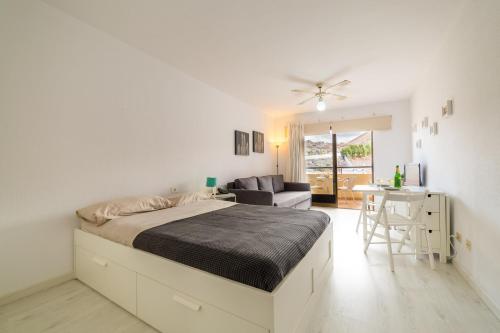 a bedroom with a bed and a living room at Casa Sara en Los Cristianos in Los Cristianos